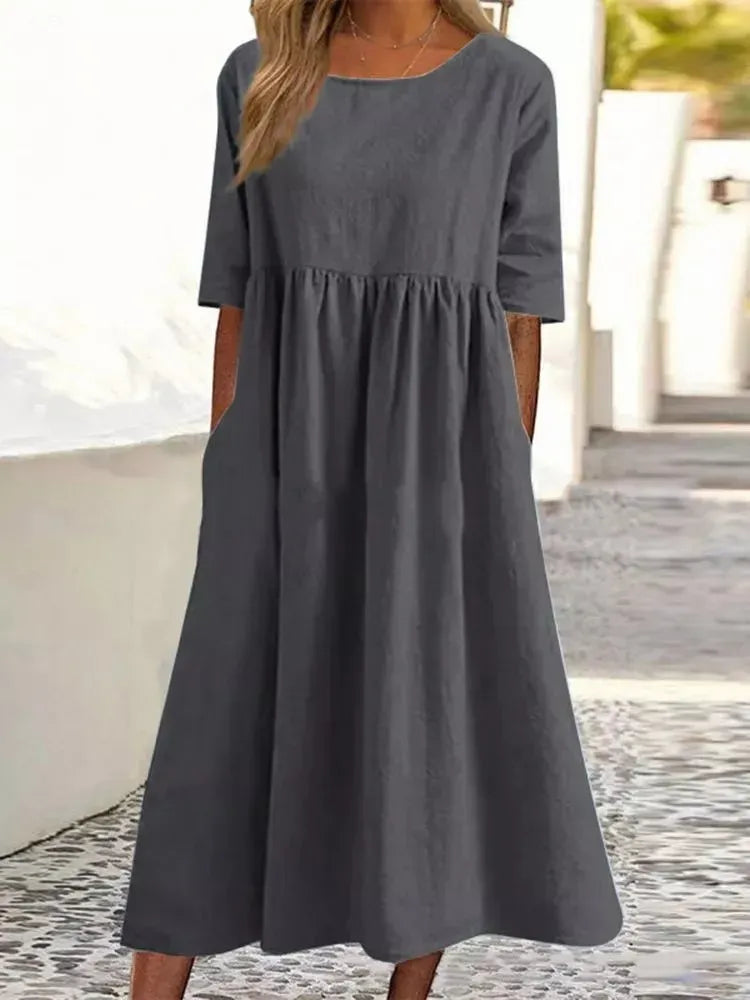 Silvia™ - Elegancka bawełniana sukienka z okrągłym dekoltem i wygodnymi kieszeniami